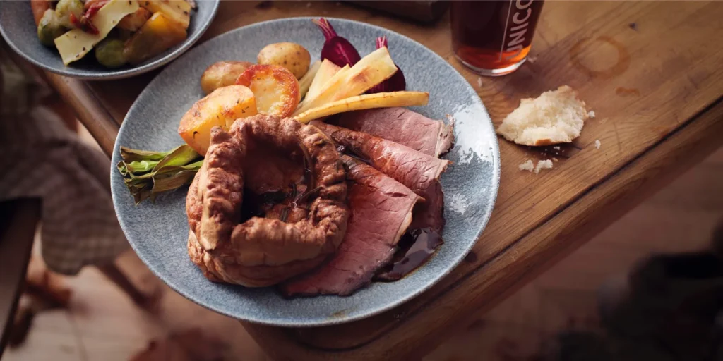 Roast beef dinner with Yorkshire pudding, roast potatoes and vegetables