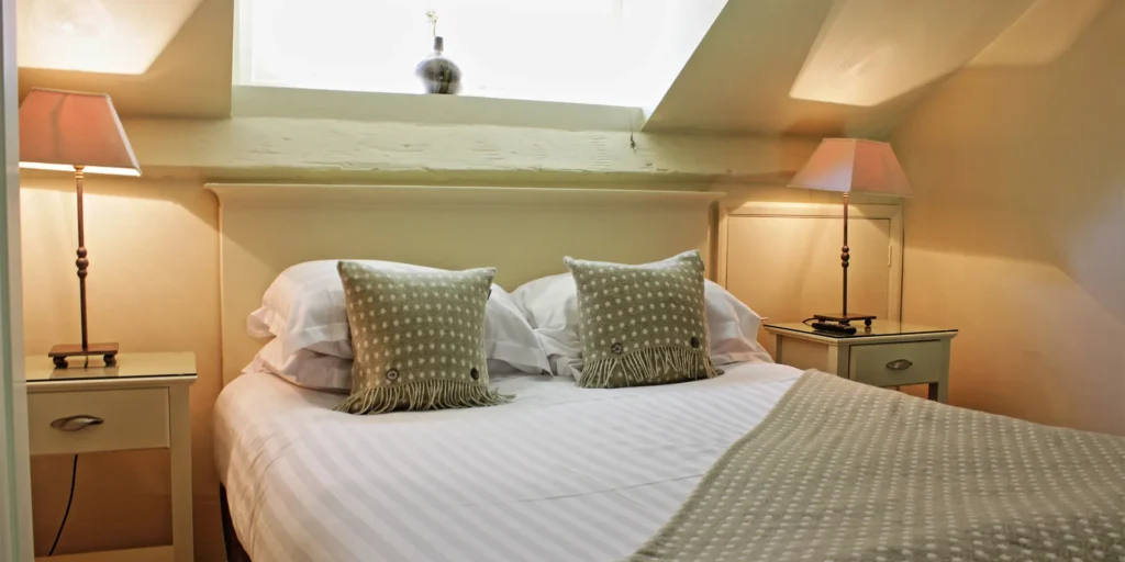 A bed which is mainly white and green