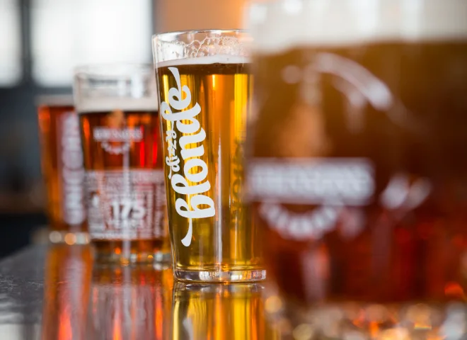 Four beer on a table with one in focus