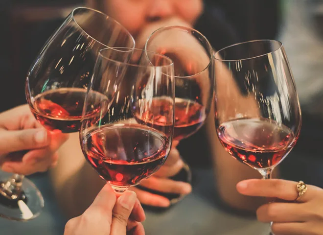 4 people clinking wine glasses