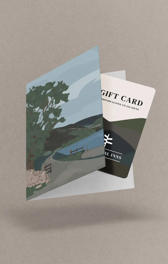 A gift card coming out of a card that has a tree, hills and a river on it. This is a drawing
