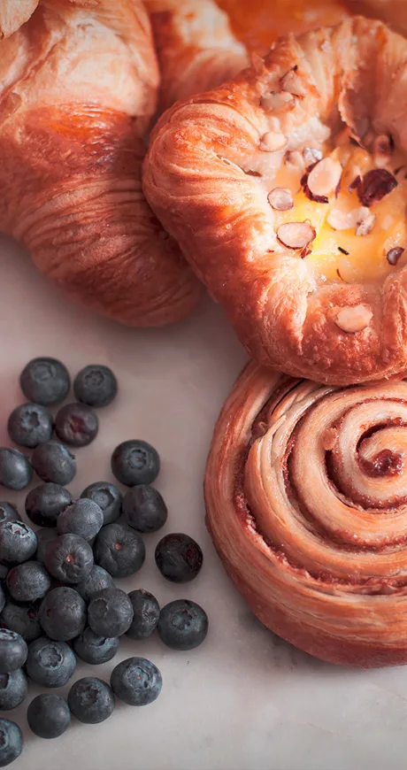 Croissants and pastries with fresh blueberries