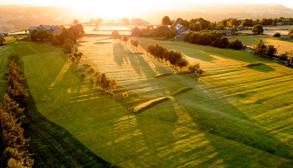 A hilly landscape and sunset in the background