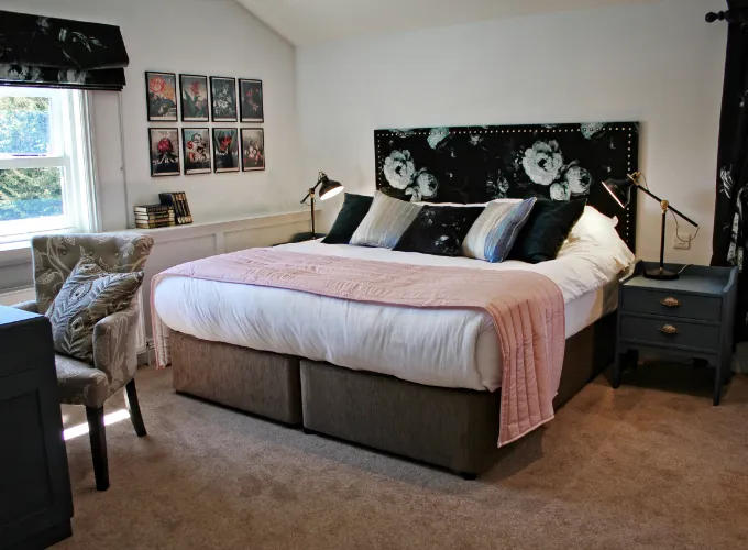 A bed which is mainly white and pink